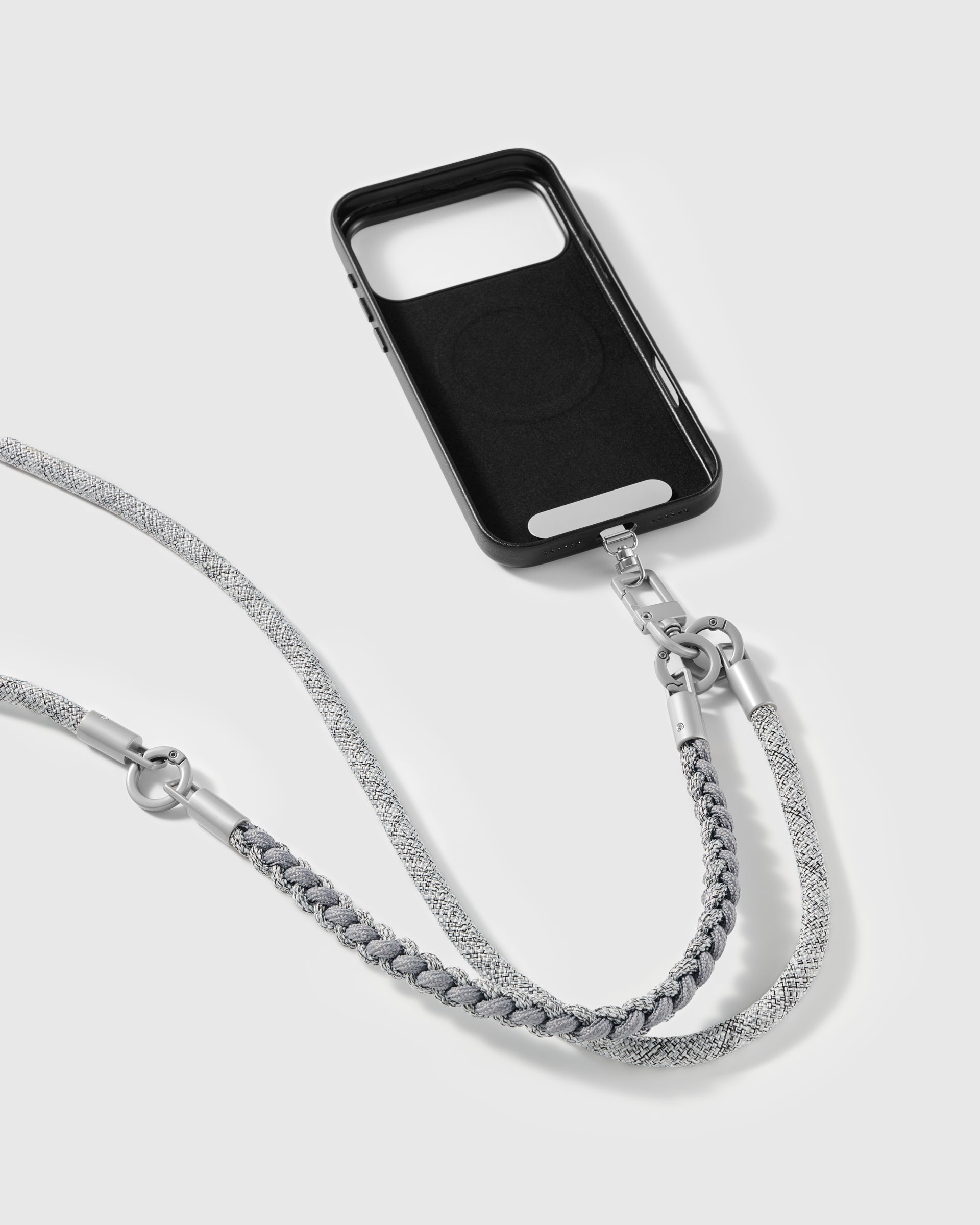 Pewter strap clipped to a black phone case for hands-free carry
