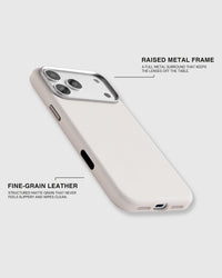 Fine-grain leather grain and the full raised metal camera surround on the white iPhone case