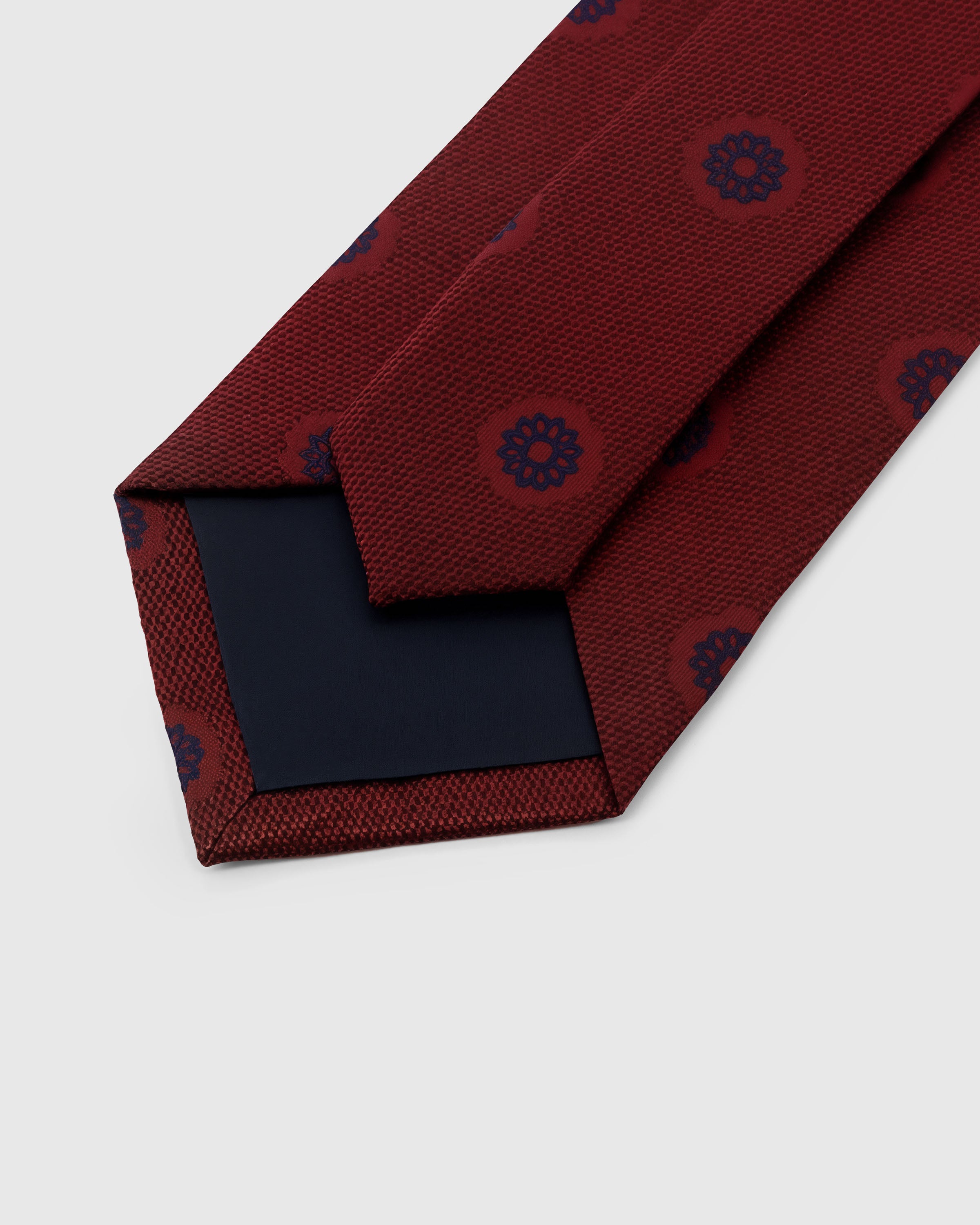 STICKYZOO Burgundy Rosette Tie back detail showing structured interlining and hand-finished slip stitching, 145 × 8 cm