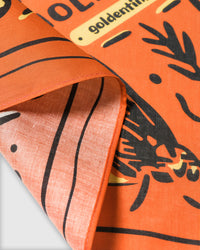 Close-up of the river trout silk scarf showing the inked fishing motif and the silk weave on the reverse
```