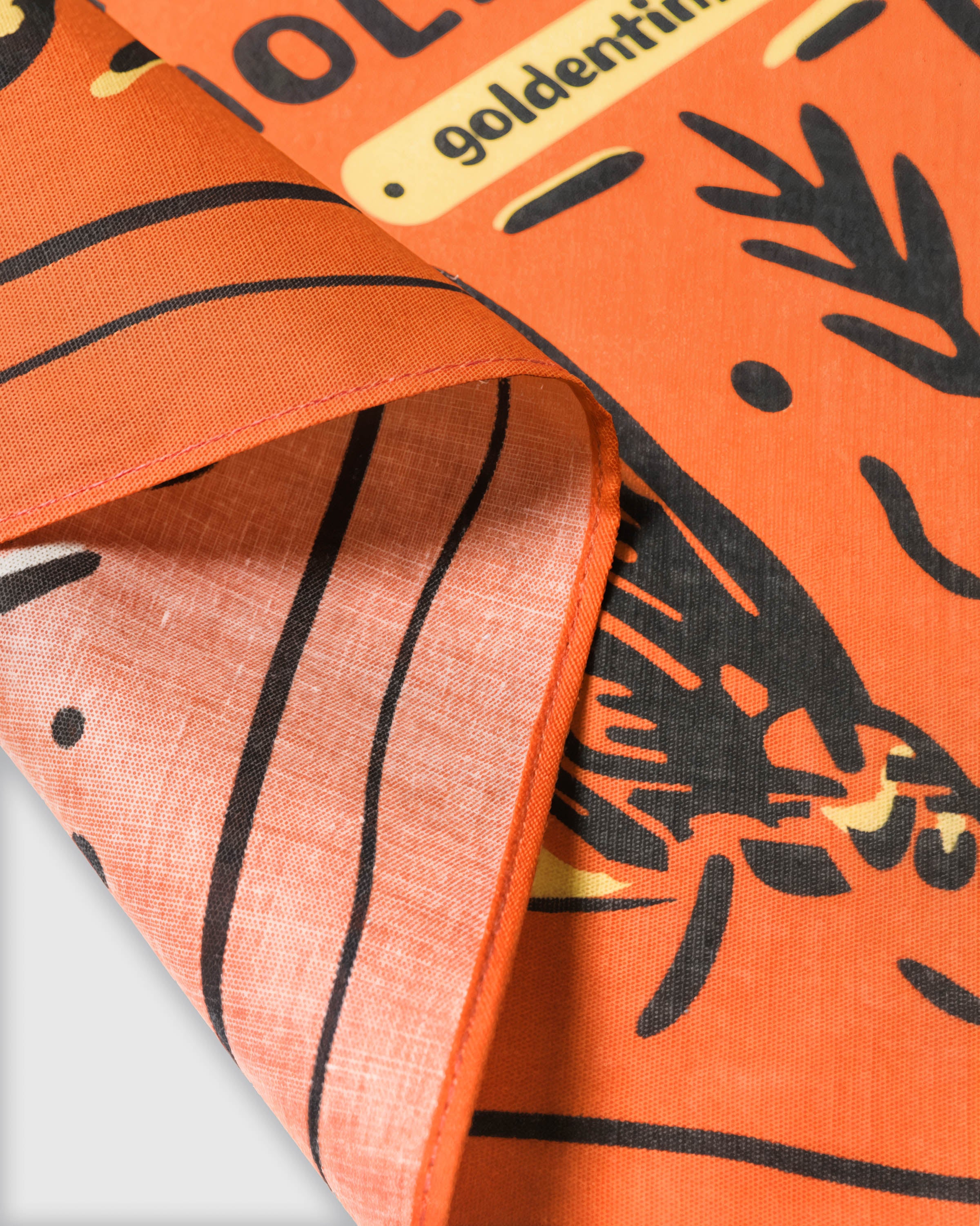 Close-up of the river trout silk scarf showing the inked fishing motif and the silk weave on the reverse
```