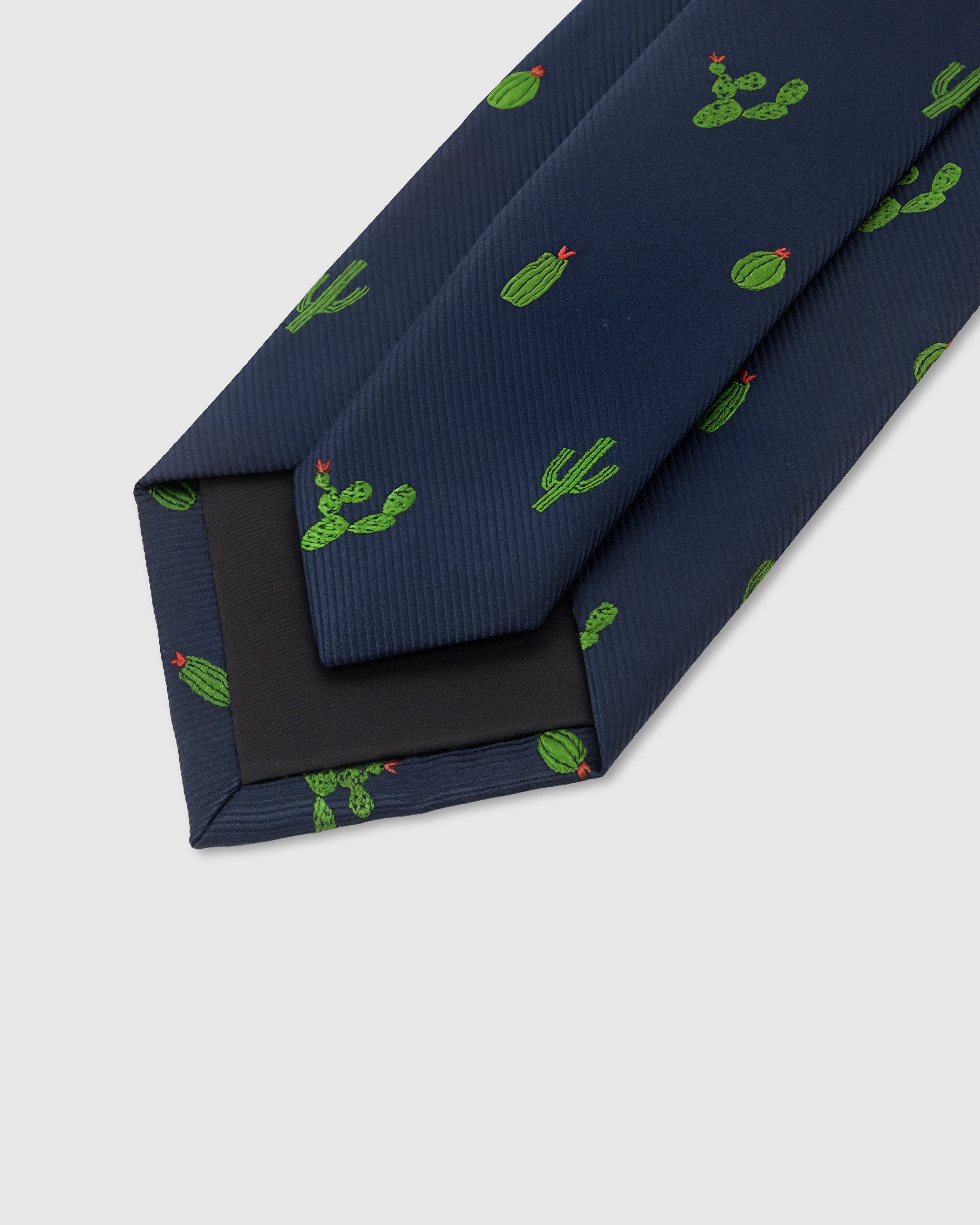 STICKYZOO Navy Cactus Tie back detail showing structured interlining and hand-finished slip stitching, 145 × 8 cm