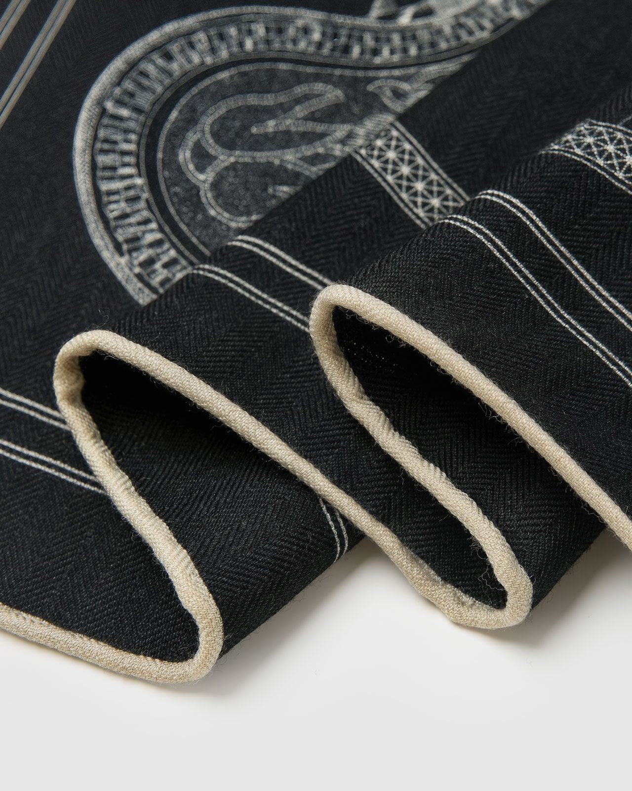 STICKYZOO noir engraving silk scarf wrapped in a casual drape showing the engraved saddle motif