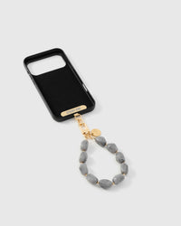 Inside of phone case showing STICKYZOO Phone Strap Card with grey marble strap attached