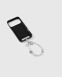 Silver beaded wrist strap clipped to a black phone case, silver puff heart, faceted clear bead, grey pearl-effect bead and STICKYZOO disc