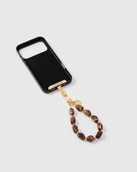 Inside of phone case showing STICKYZOO Phone Strap Card with gold hardware connection