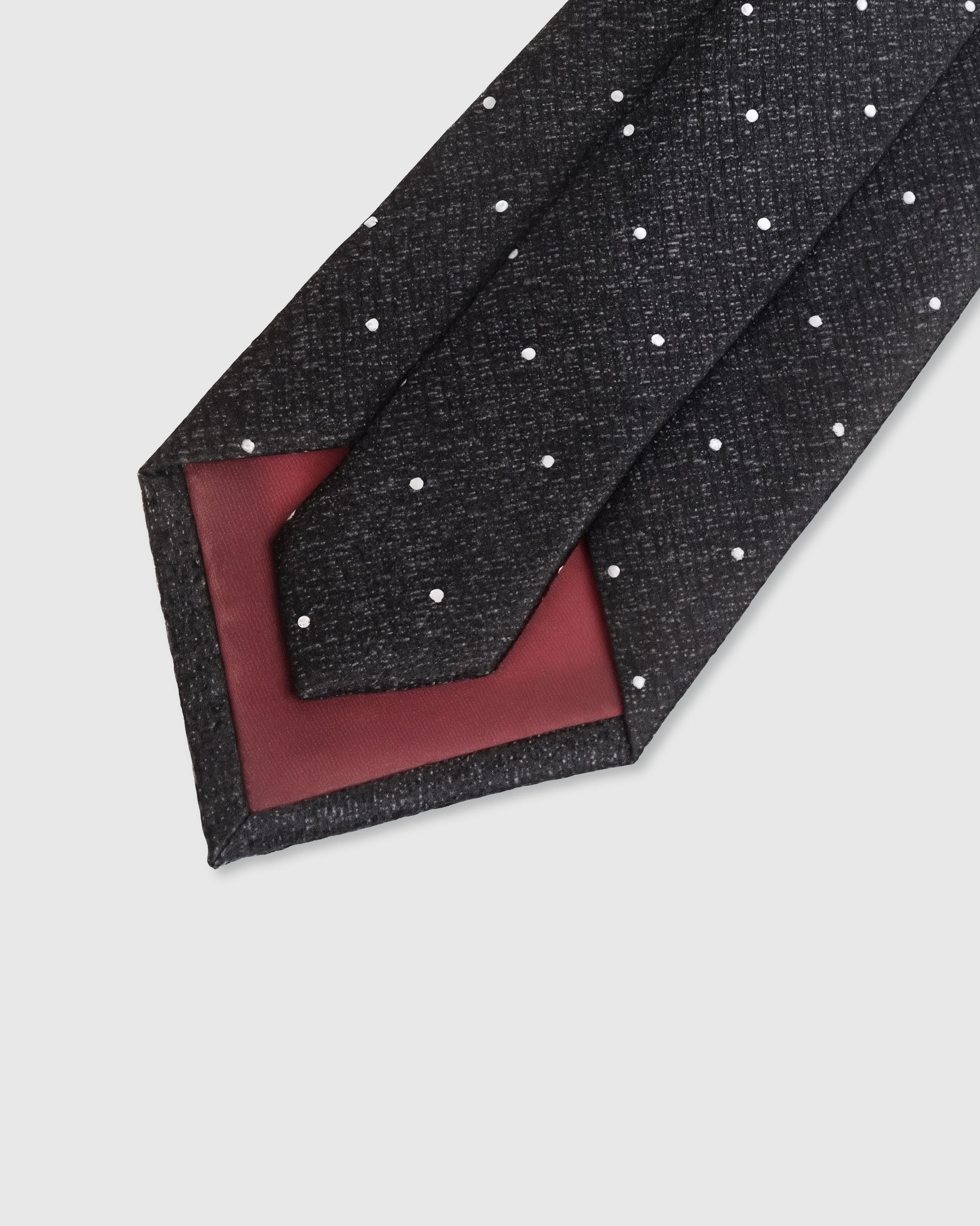 {Hand-finished interior} STICKYZOO CHARCOAL PIN DOT TIE back detail showing structured interlining and hand-finished slip stitching, 145 x 8 cm