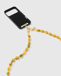 Golden smoke link phone strap attached to black phone case showing cross-body carry
