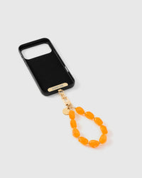 Inside of phone case showing STICKYZOO Phone Strap Card with gold hardware