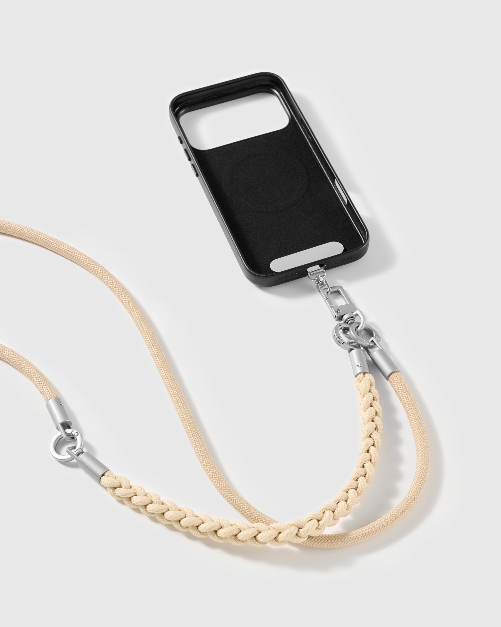 Sand strap clipped to a black phone case for hands-free carry