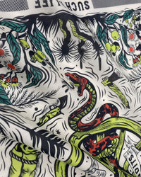 Detail of the printed serpent in chartreuse and red on the STICKYZOO serpent thicket silk scarf
```