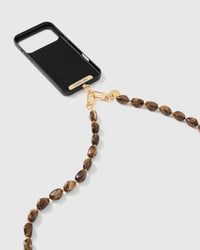 Amber smoke link phone strap attached to black phone case showing cross-body carry functionality