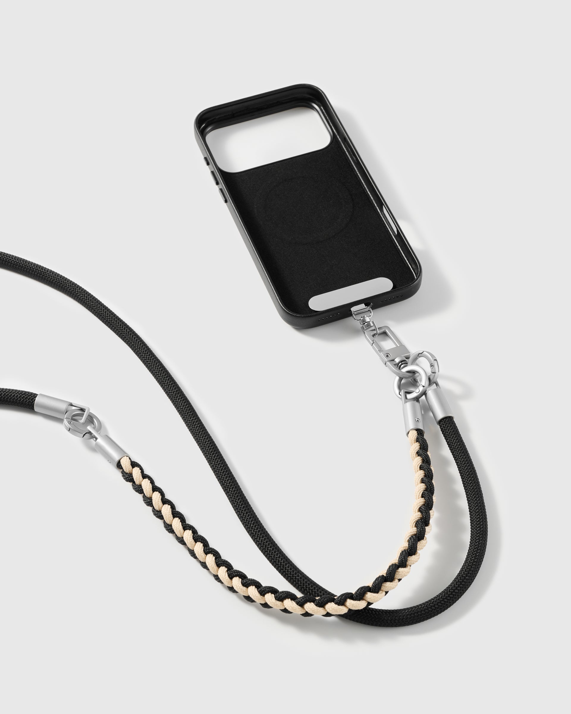 Cross-body phone strap clipped to a phone case for hands-free carry