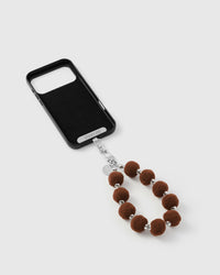 Close-up of silver-tone engraved clasp and STICKYZOO charm disc with plush beads