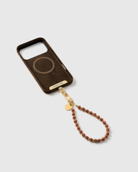 Inside of a phone case showing the included Phone Strap Card that anchors the beaded wrist strap