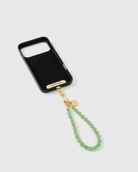 Inside of phone case showing STICKYZOO Phone Strap Card with sage orbit strap attached