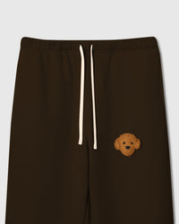 Close-up of curly plush poodle face on dark brown cotton showing tonal 3D detail