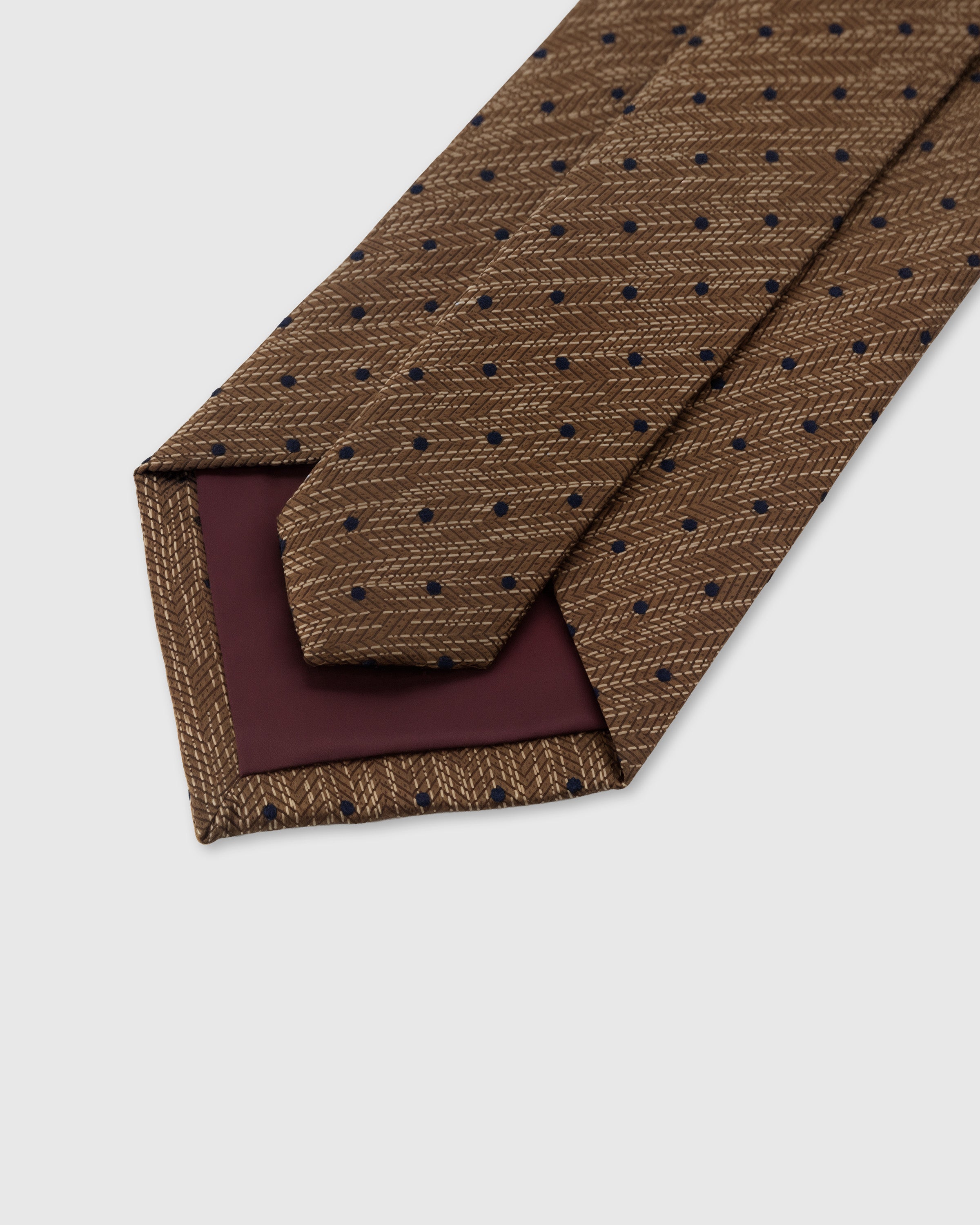 STICKYZOO Caramel Pindot Tie construction detail showing 45° bias cut, structured interlining and slip stitching, 145 x 8 cm