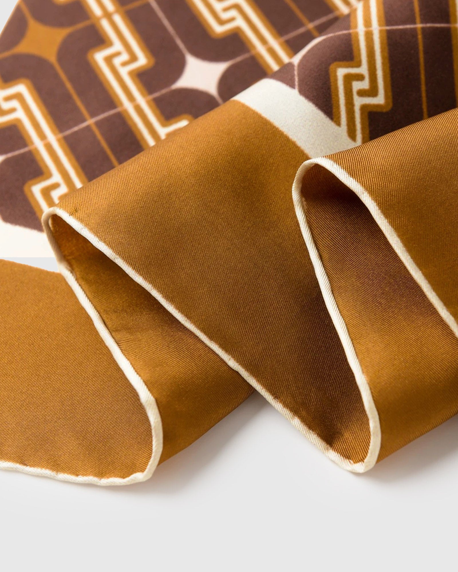 Close-up of the tobacco border and cream inner frame printed in archival inks on pure silk