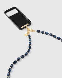 Full phone with midnight smoke strap draped alongside on neutral background