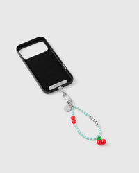 Inside of phone case showing STICKYZOO Phone Strap Card with mint cherry strap attached