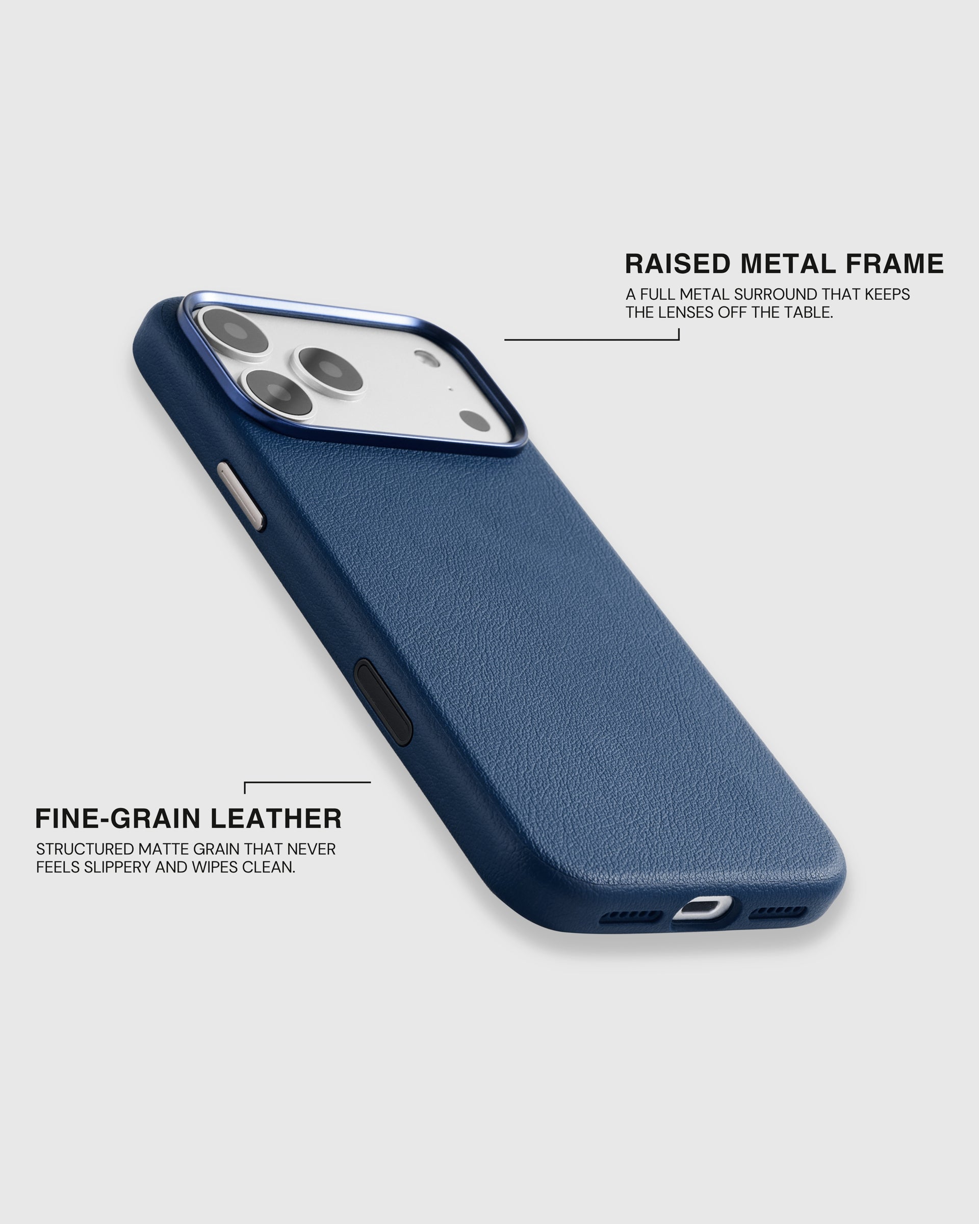 Fine-grain leather grain and the full raised metal camera surround on the navy iPhone case