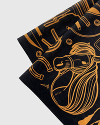 Close-up of the hand-illustrated horse and tequila bottle motif printed in archival copper ink on silk