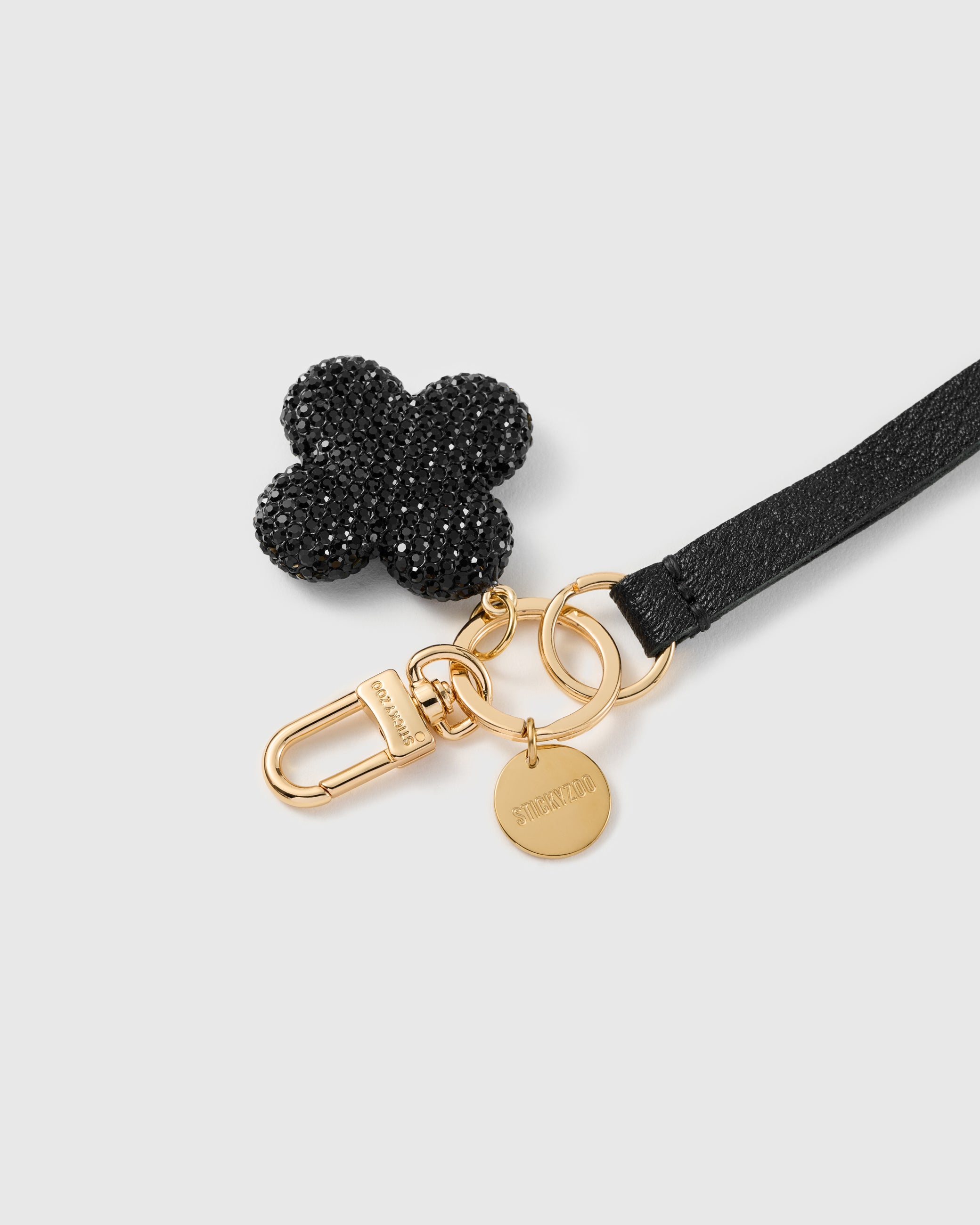 Midnight clover leather phone strap clipped to a phone case showing the hands-free wrist loop