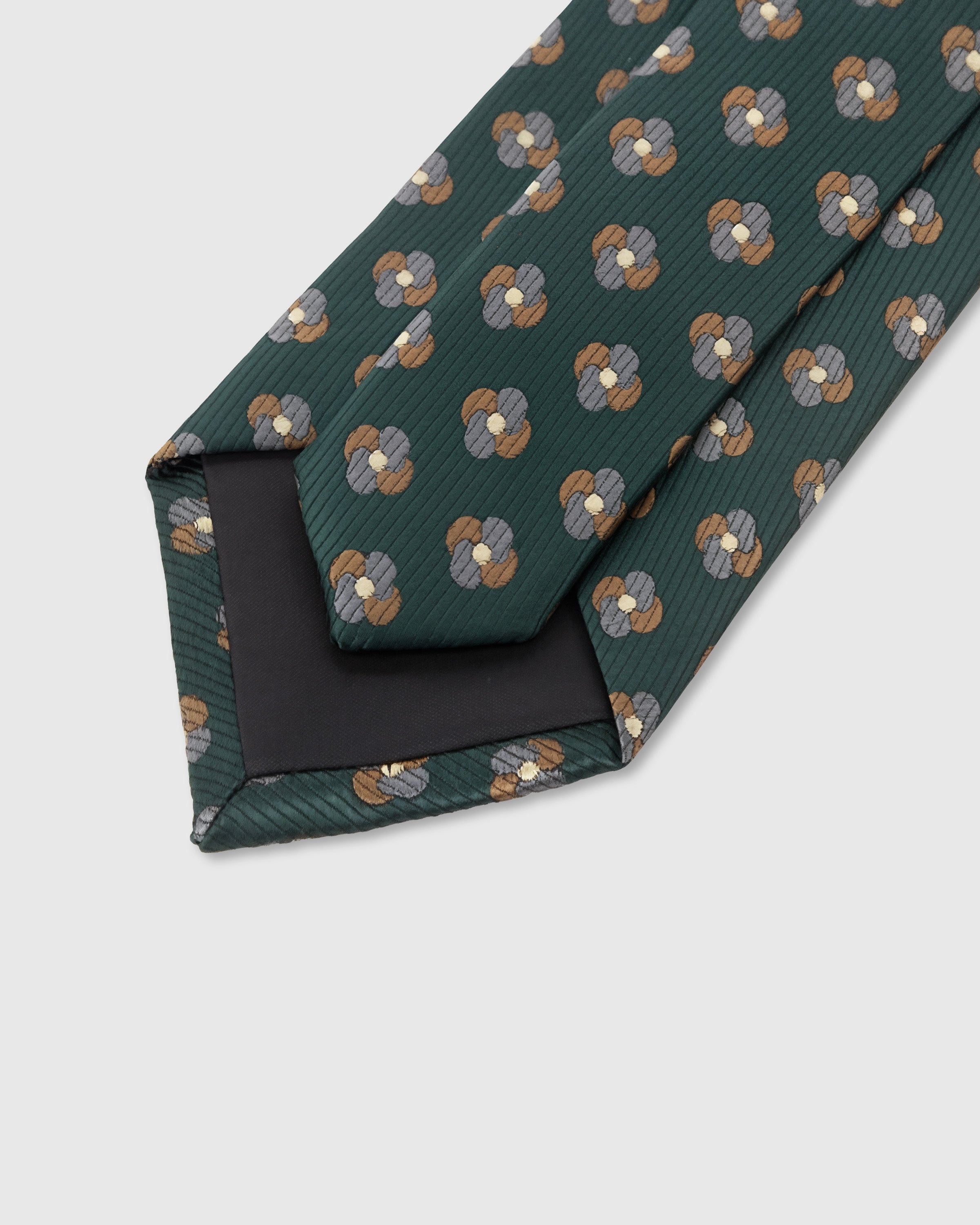 STICKYZOO Pine Clover Tie construction showing structured interlining and hand-finished slip stitching, 100,000+ sold