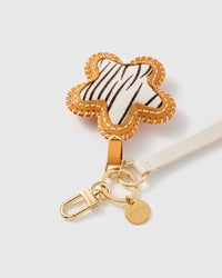 Close-up of the hand whip-stitched STICKYZOO zebra calf-hair star charm showing real hair-on texture