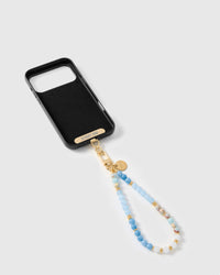 Inside of black phone case showing STICKYZOO Phone Strap Card with azure agate strap attached