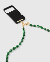 Emerald smoke link phone strap attached to black phone case showing cross-body carry