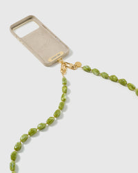 STICKYZOO moss cross-body strap clipped to a phone case with dual gold-plated clasps, showing universal fit via the included Phone Strap Card