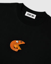Ribbed crew neckline and woven label on the black oversized cotton tee with the beaded shrimp appliqué below