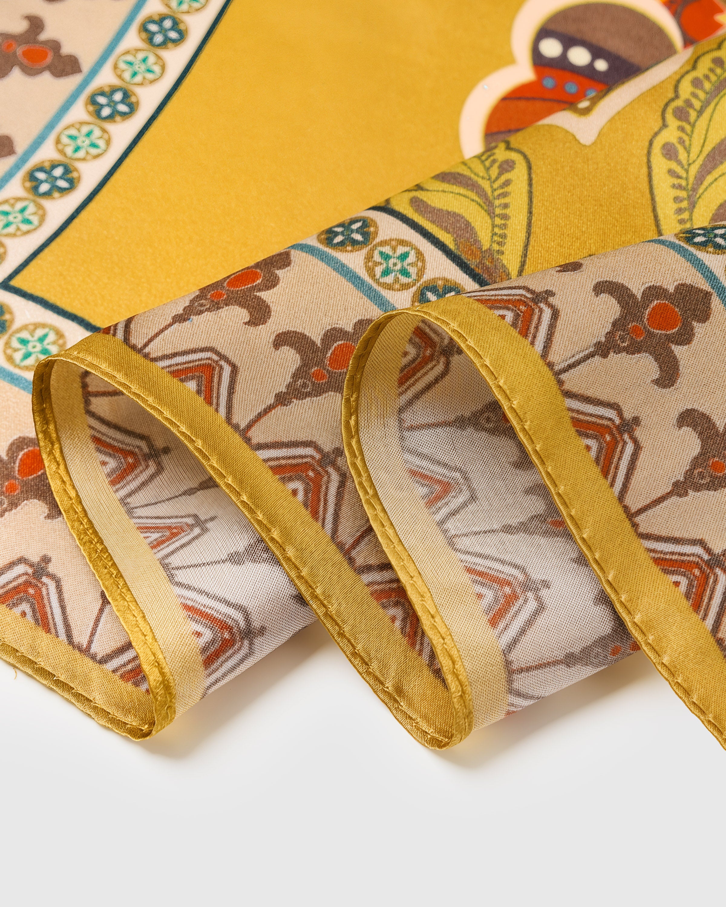 Close-up of the hand-illustrated medallion border printed in archival inks on pure silk