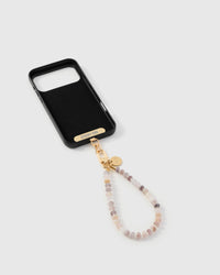 Inside of phone case showing STICKYZOO Phone Strap Card with blush agate strap attached