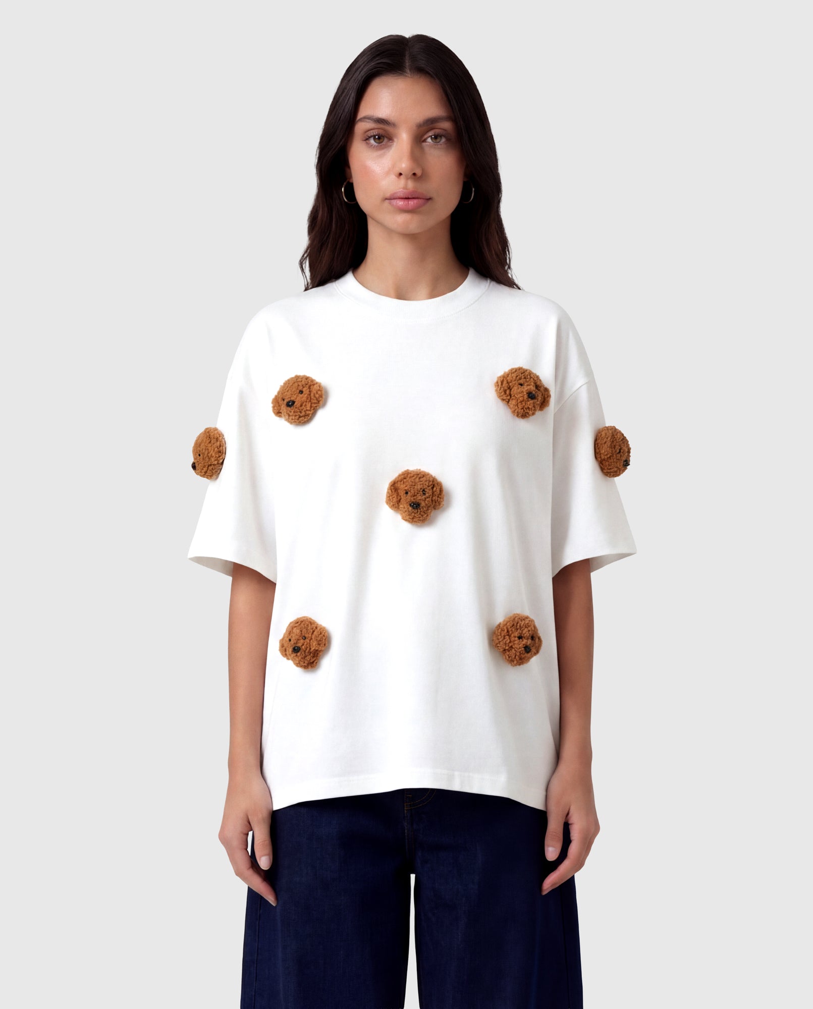 Model in white Poodle Parade T-Shirt front view showing all seven plush poodle appliques