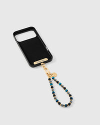 Full phone with blue and black stone strap attached on light background