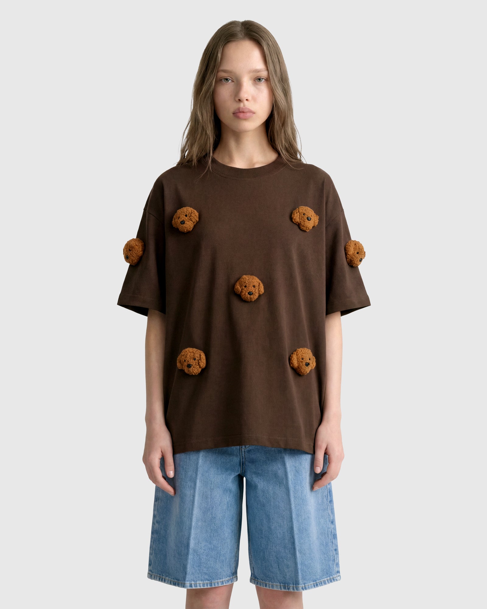 Model wearing STICKYZOO brown Poodle Parade T-Shirt showing dropped shoulders and plush poodles