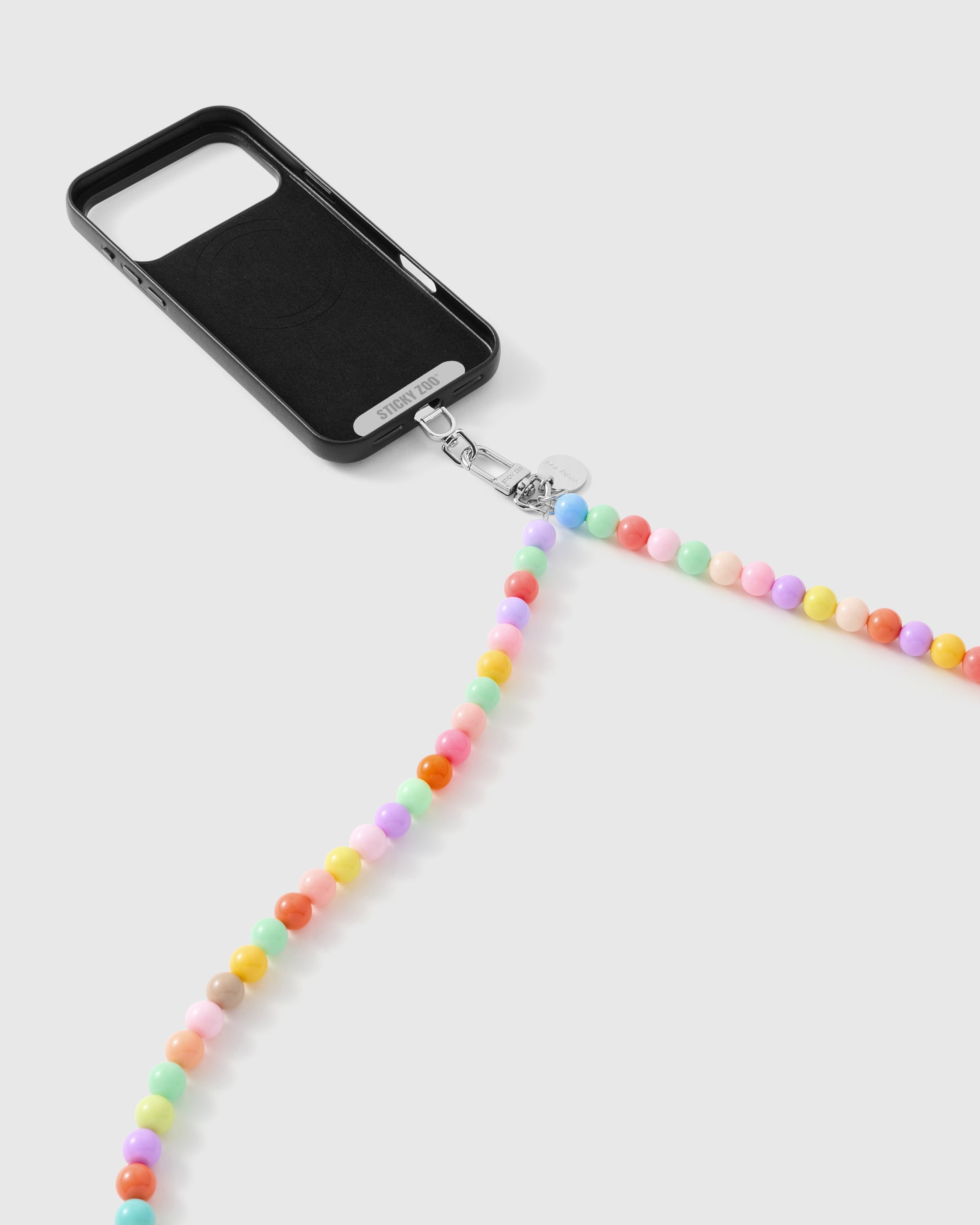 Pastel beaded phone strap attaching to a phone case using the included Phone Strap Card for a universal fit. Loved by thousands of buyers.