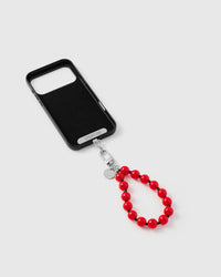 Inside of phone case showing STICKYZOO Phone Strap Card with red bead strap connected