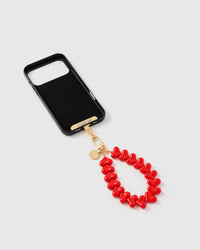 Inside of phone case showing STICKYZOO Phone Strap Card with red heart strap attached