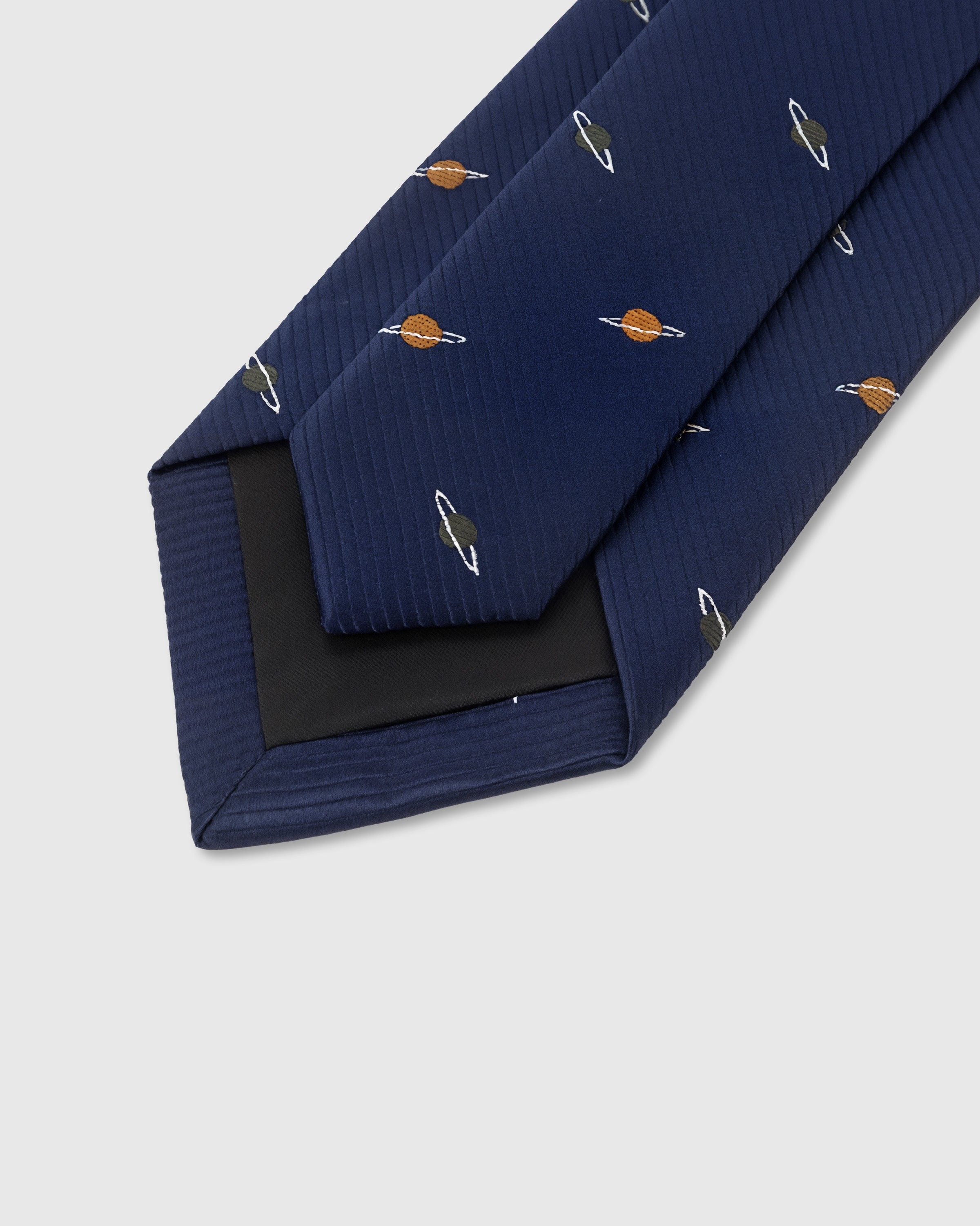STICKYZOO Navy Saturn Tie interior showing hand-finished slip stitching and structured interlining, 145 × 8 cm