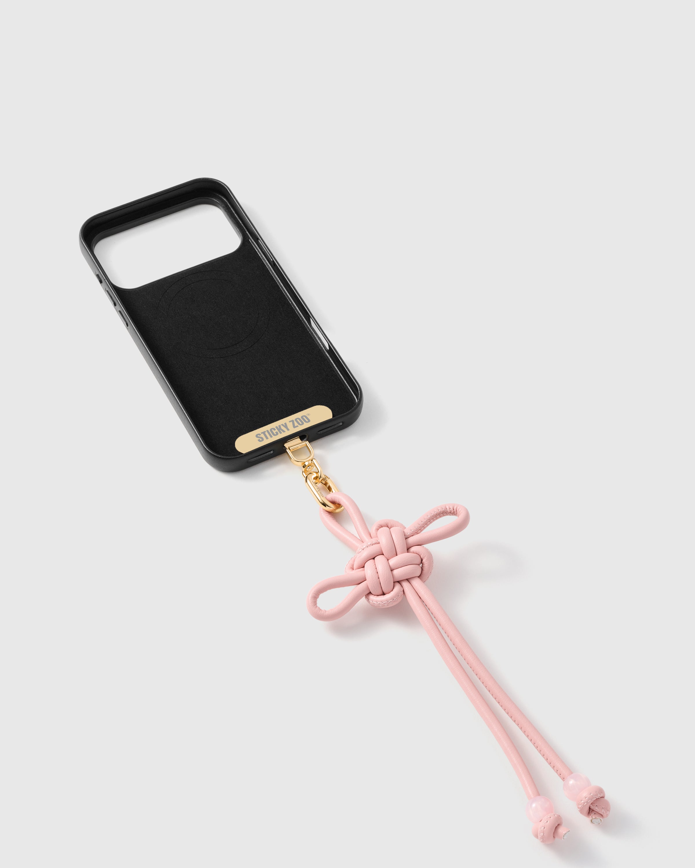 {{Strap Card included}} Inside of phone case showing STICKYZOO Phone Strap Card with rose knot strap attached