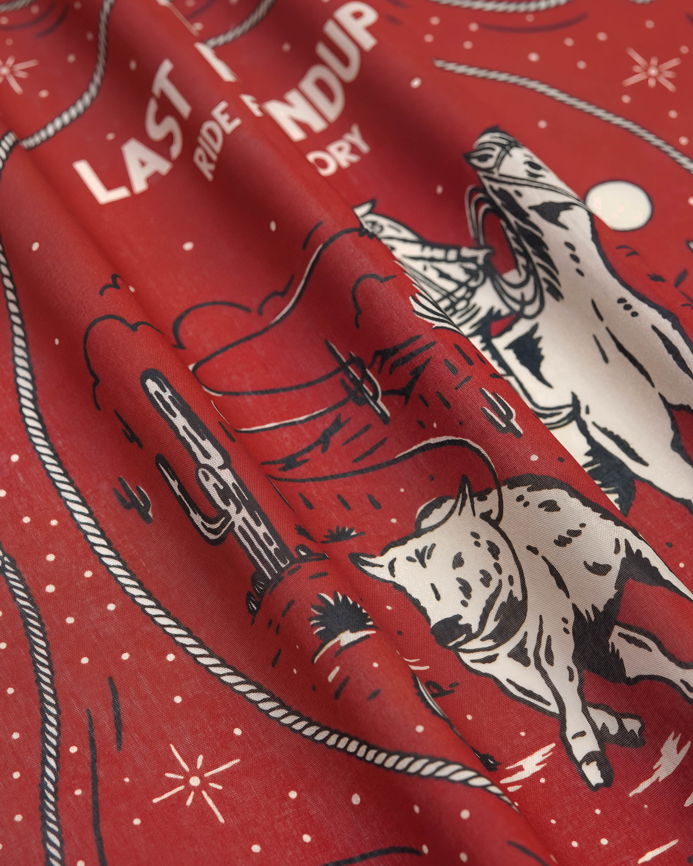 STICKYZOO last roundup silk scarf tied into a soft neckerchief knot showing how the silk drapes
```