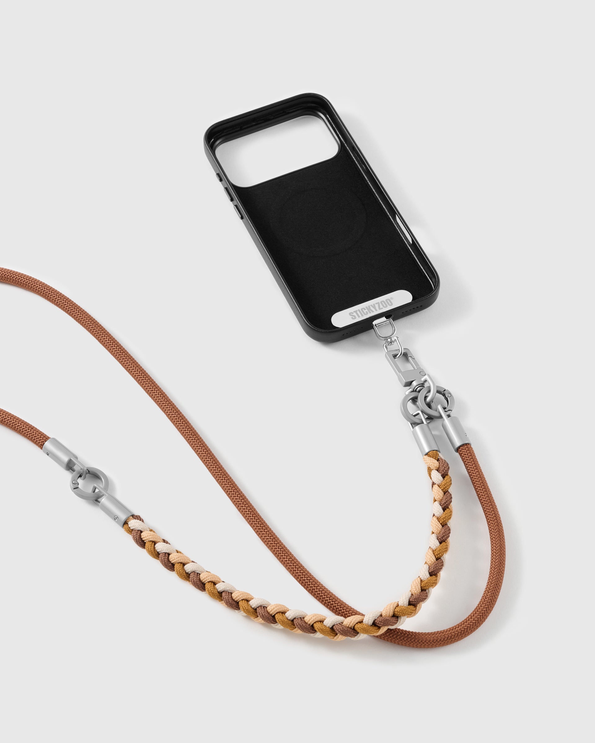 Chestnut strap clipped to a black phone case for hands-free carry
