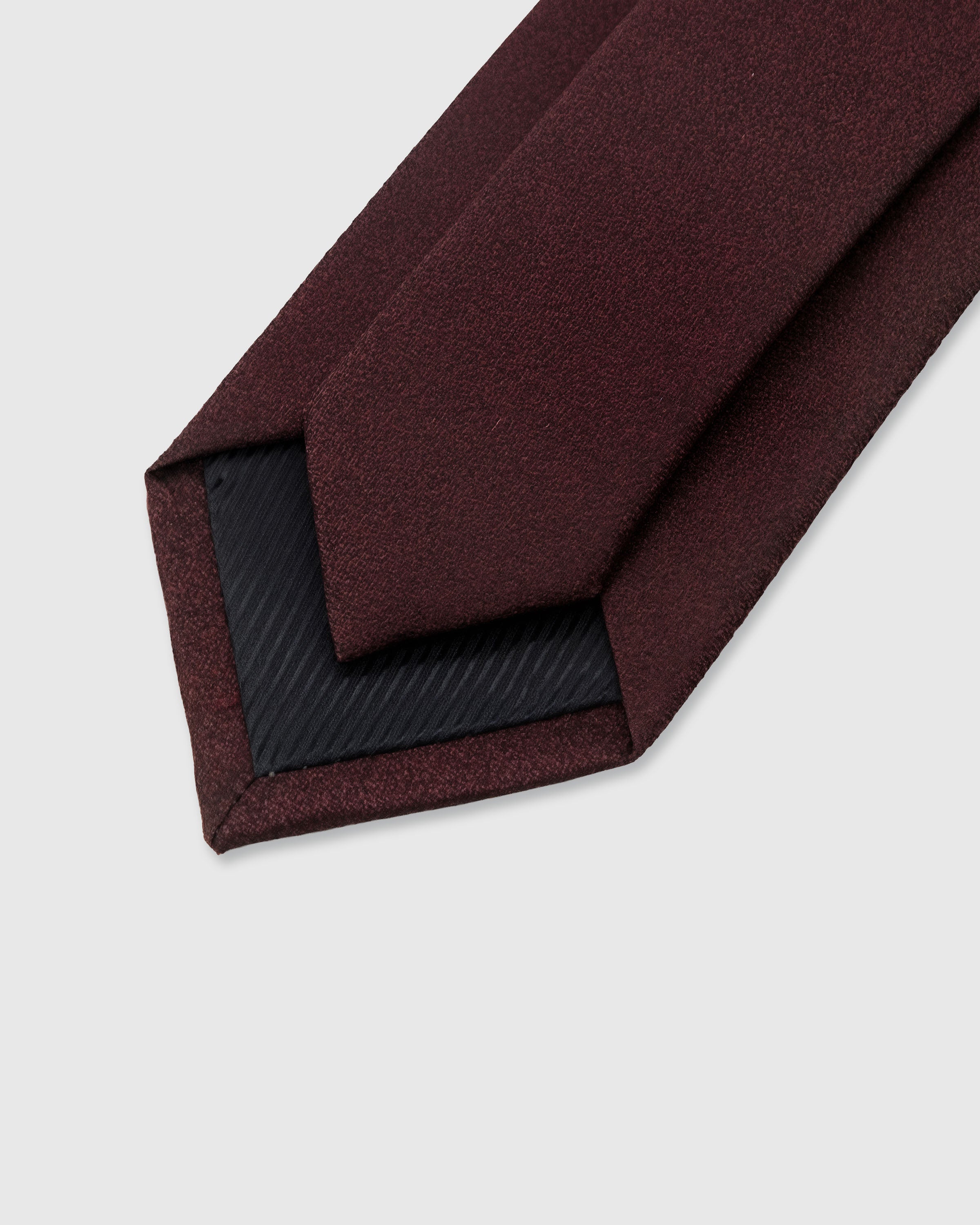 {Hand-finished interior} STICKYZOO OXBLOOD SATIN TIE back detail showing structured interlining and hand-finished slip stitching, 145 x 8 cm