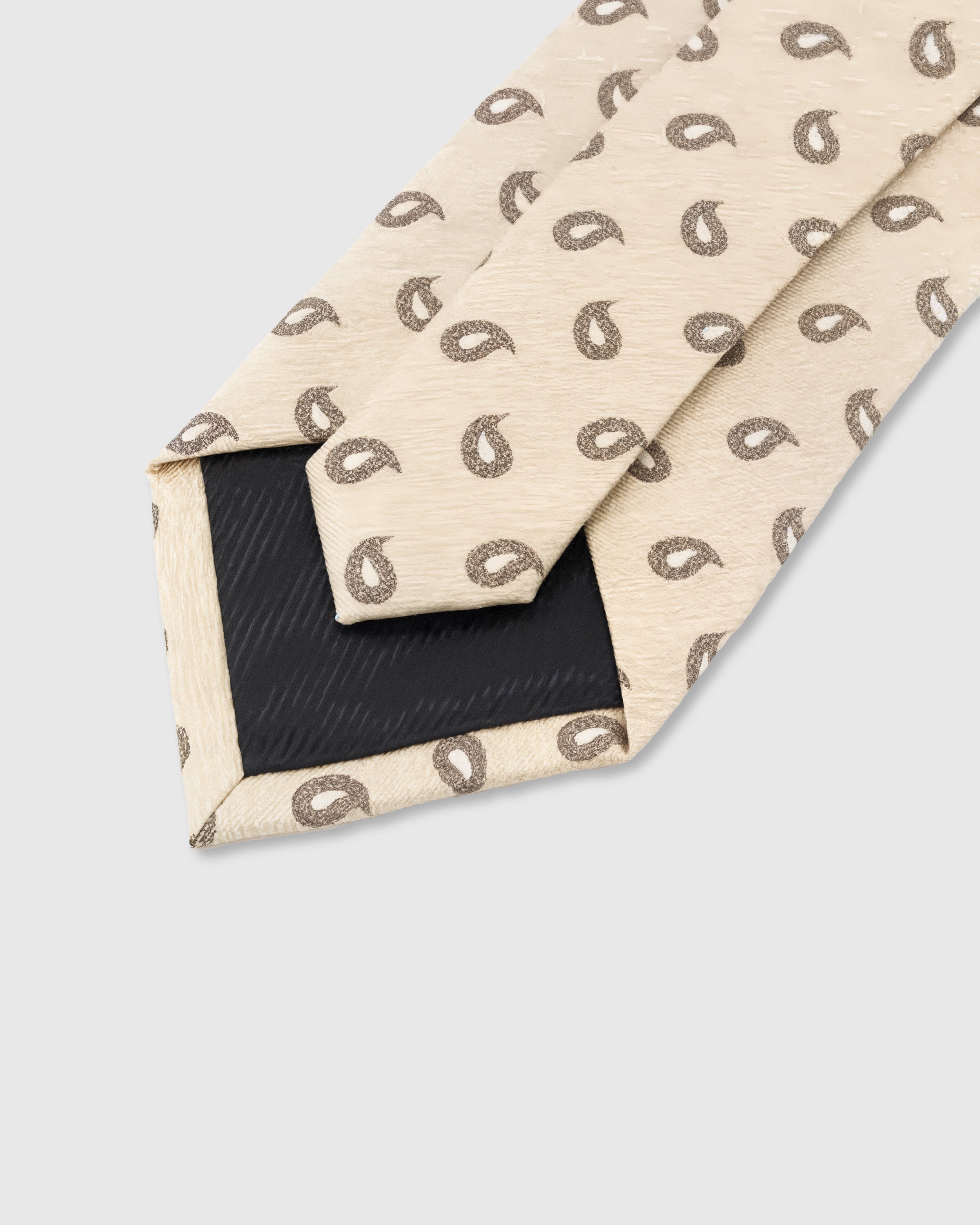 STICKYZOO Sand Paisley Tie showing 45° bias-cut Italian method construction and natural silk drape, 145 × 8 cm