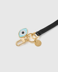 Night guardian leather phone strap clipped to a phone case showing the hands-free wrist loop in use