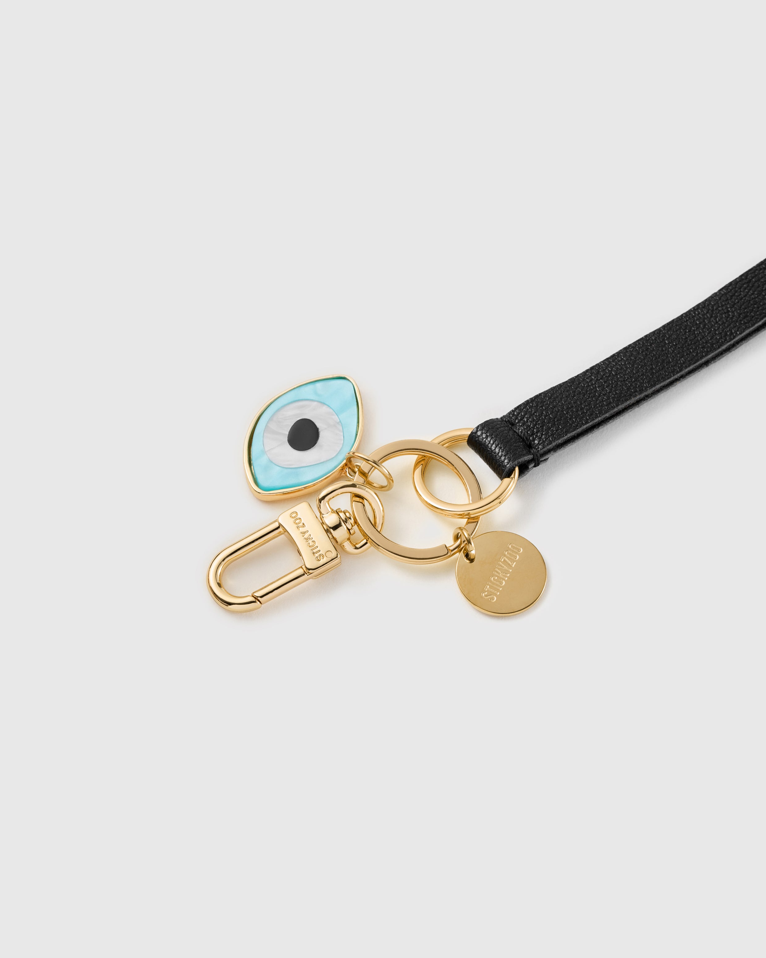 Night guardian leather phone strap clipped to a phone case showing the hands-free wrist loop in use